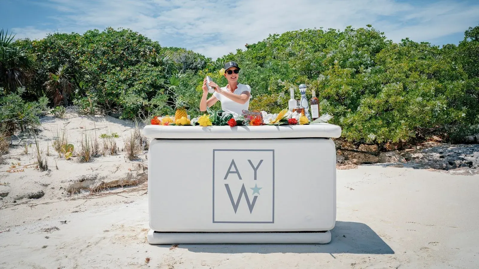 AS YOU WISH's crew at the yacht's own bar, set up on a beach in the Exumas
