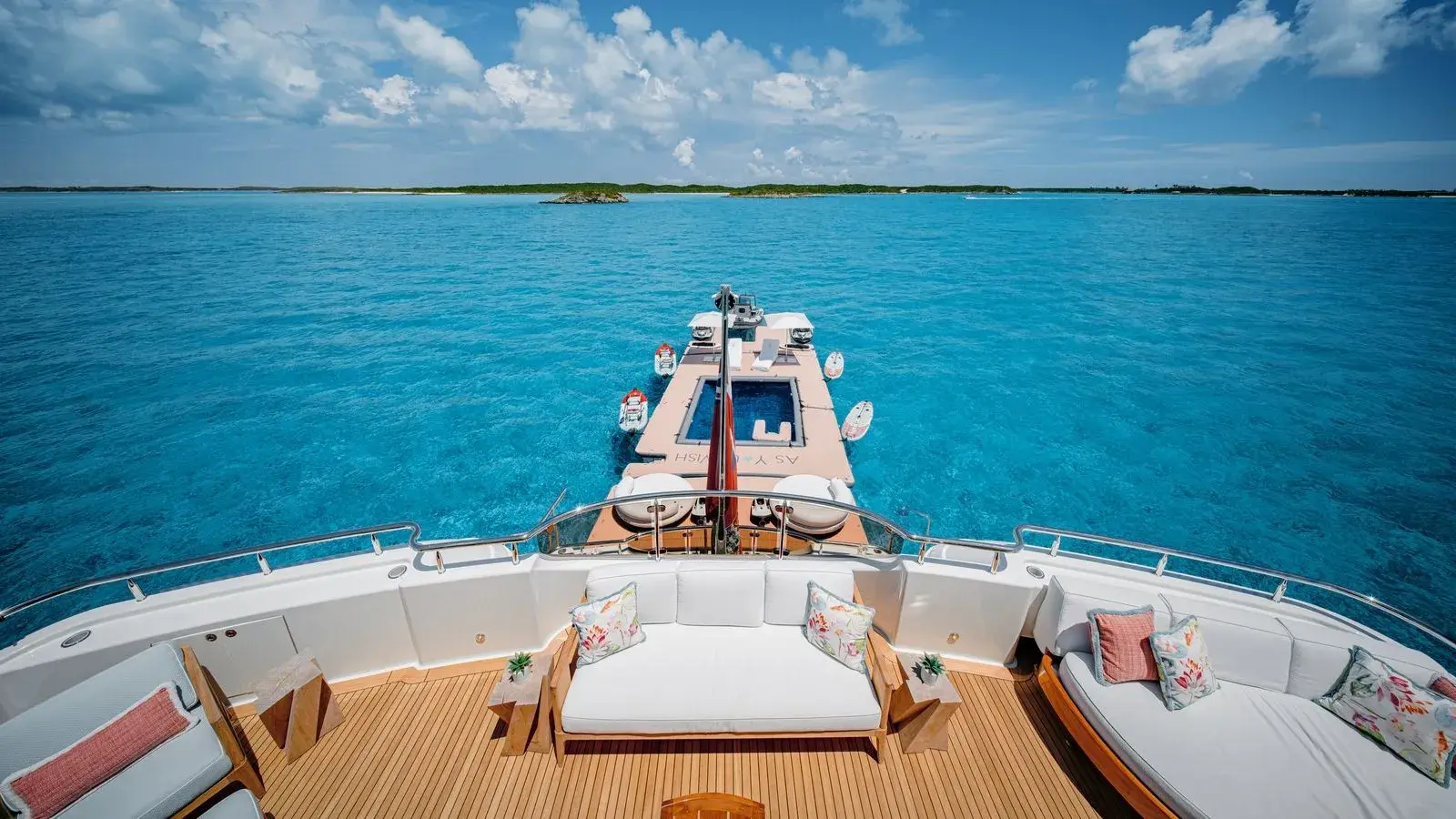 AS YOU WISH — the foredeck sunpads, the Exumas bank ahead