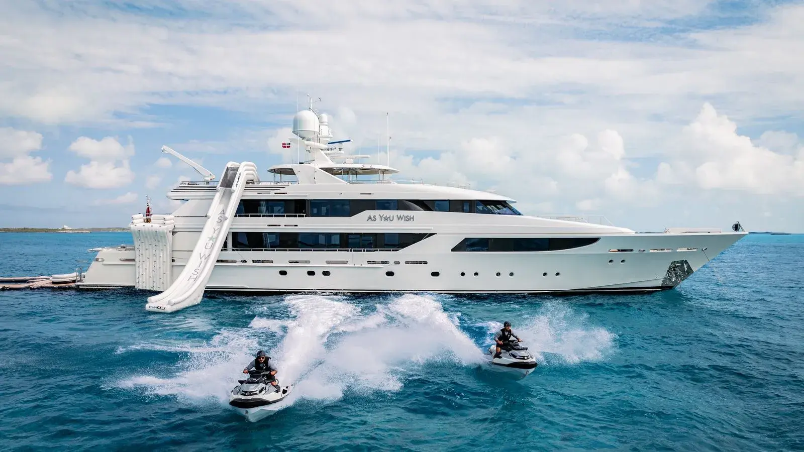 AS YOU WISH at anchor in the Exumas, the slide down from the sundeck, two jet skis running past